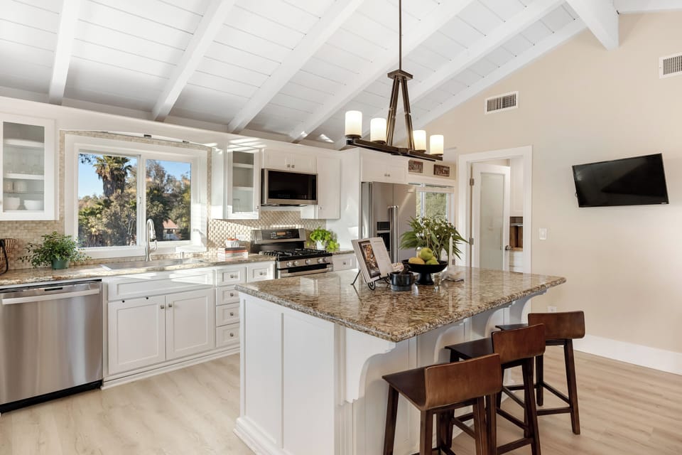 Additional barstool seating at the kitchen island.