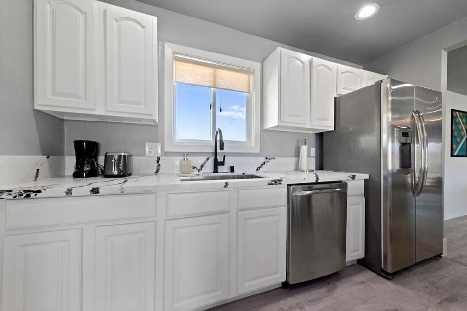 Step into this chic, modern kitchen—where sleek finishes meet culinary luxury.