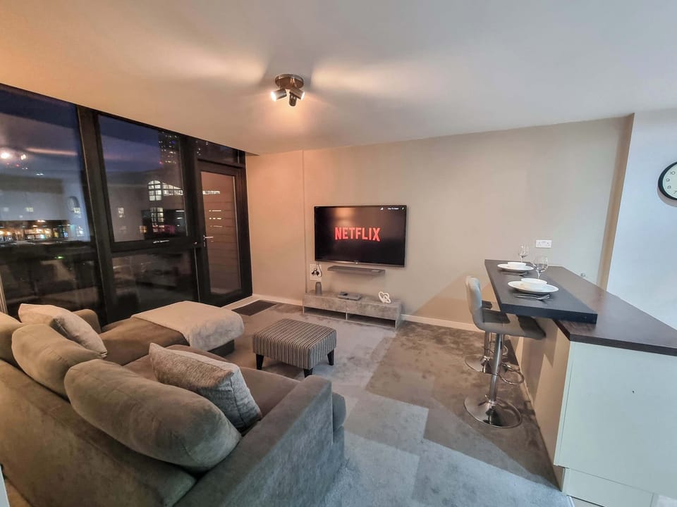 A stylish, open-concept living area with comfortable seating, ready to host your next movie night or game evening