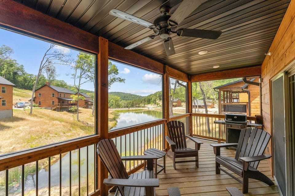 Large Covered Deck with Seating, Hot Tub, and Fishing Pond View