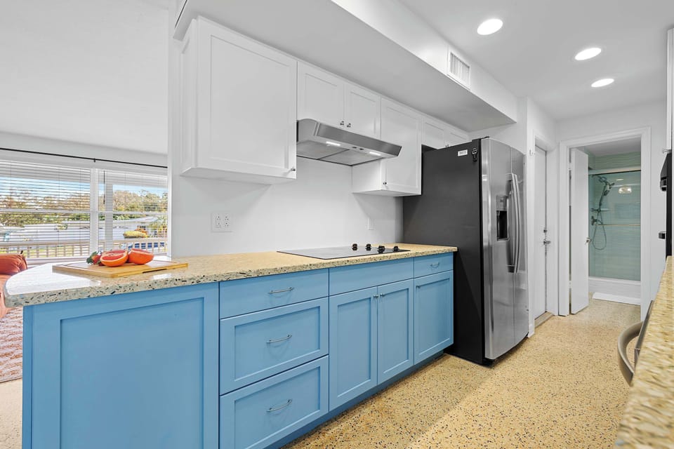 Spacious kitchen w/ blue cabinetry and plenty of prep space.