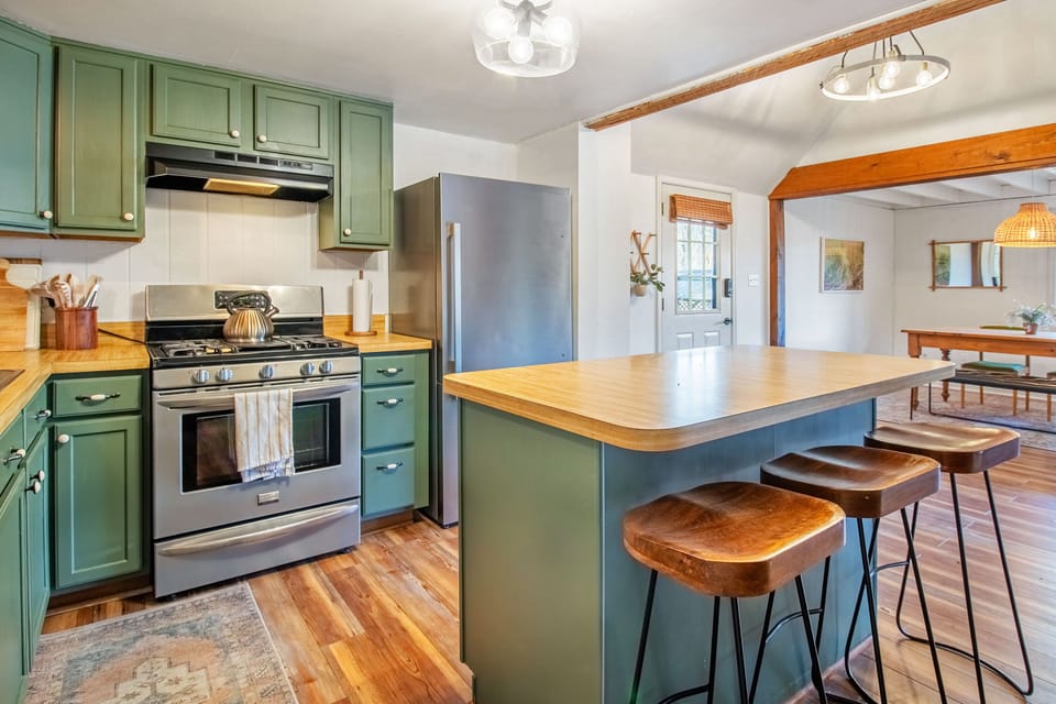 Full kitchen with stove top, oven, refrigerator, microwave, bar seating, and more!