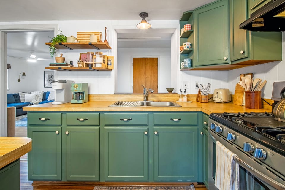 Full kitchen with stove top, oven, refrigerator, microwave, bar seating, and more!