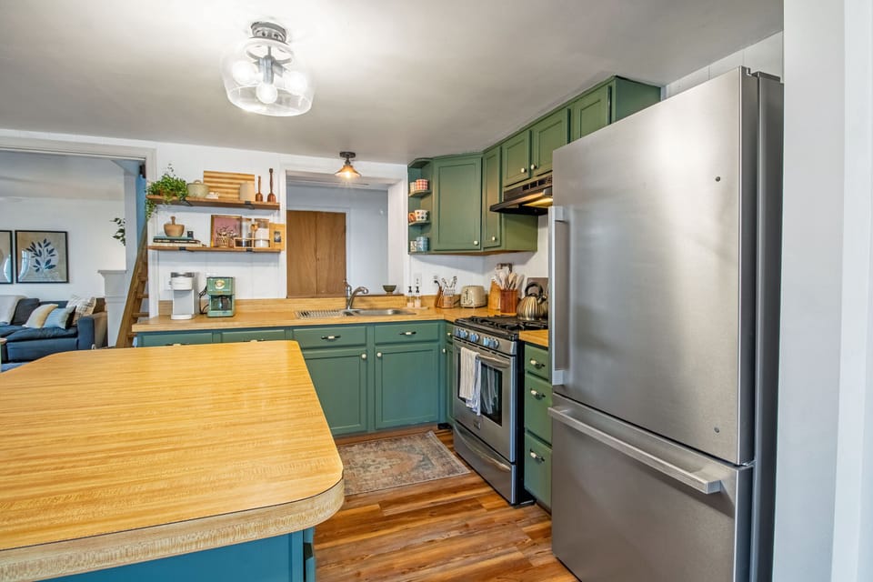 Full kitchen with stove top, oven, refrigerator, microwave, bar seating, and more!