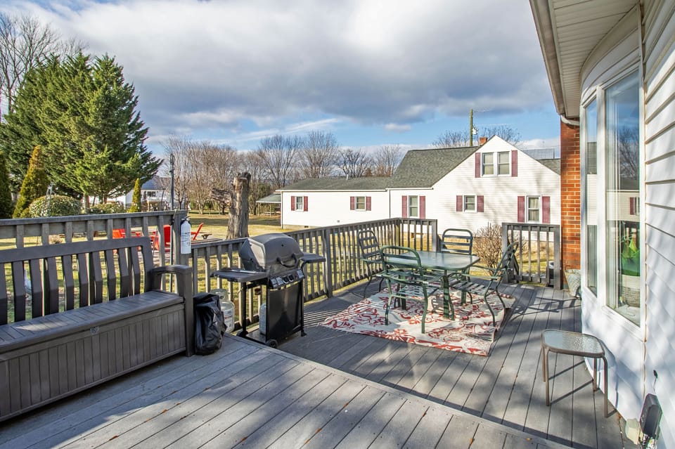 Back deck with outdoor seating, grill area, and private hot tub