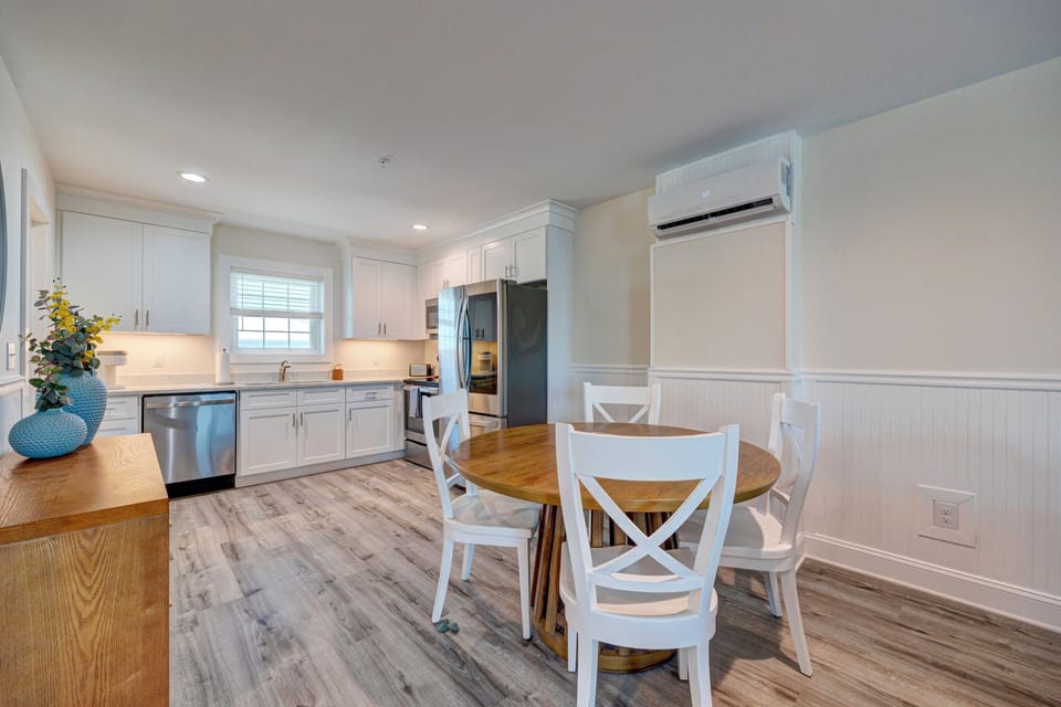 Your bright, airy kitchen features white cabinetry, stainless appliances, and a cozy dining nook where you'll start each morning with coffee.