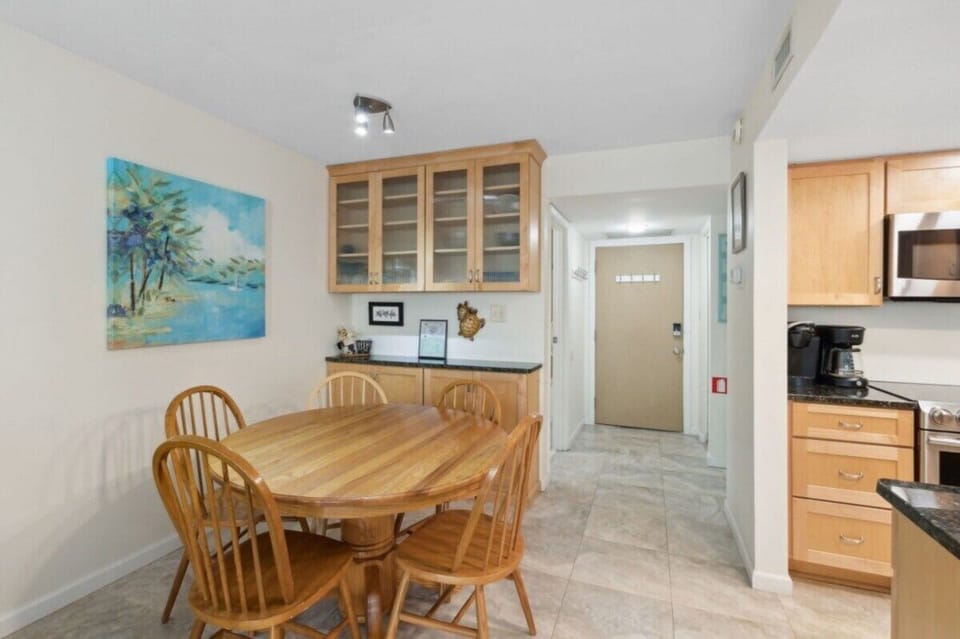 Dining area with a table for six, added cabinet storage, and counter space.