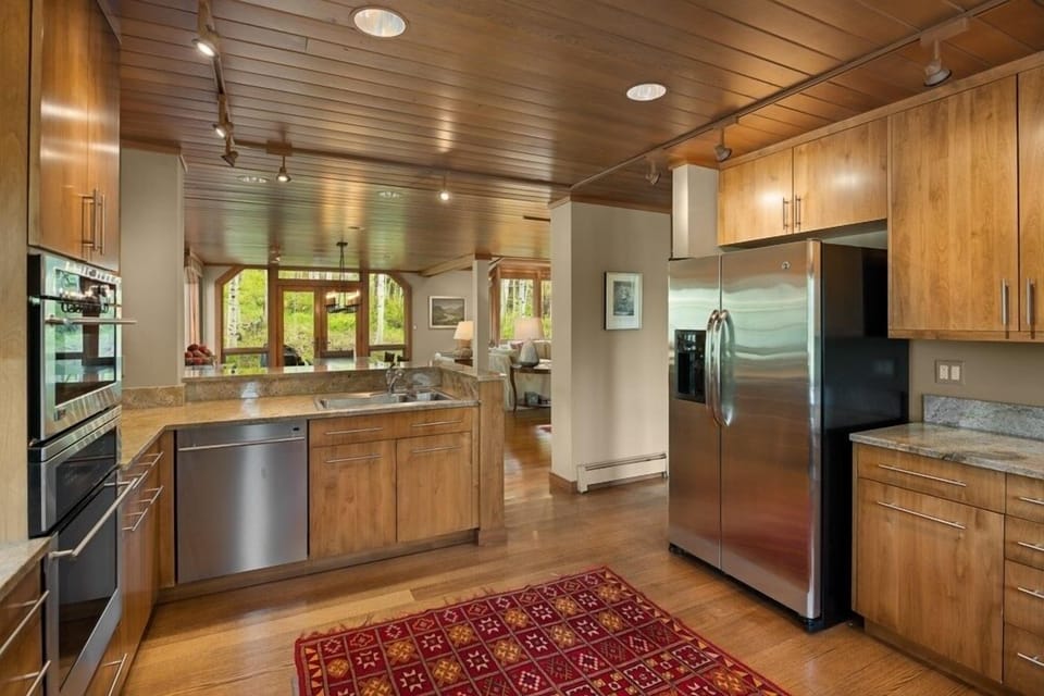 The updated kitchen with custom cabinets, stainless appliances and a cozy breakfast area.
