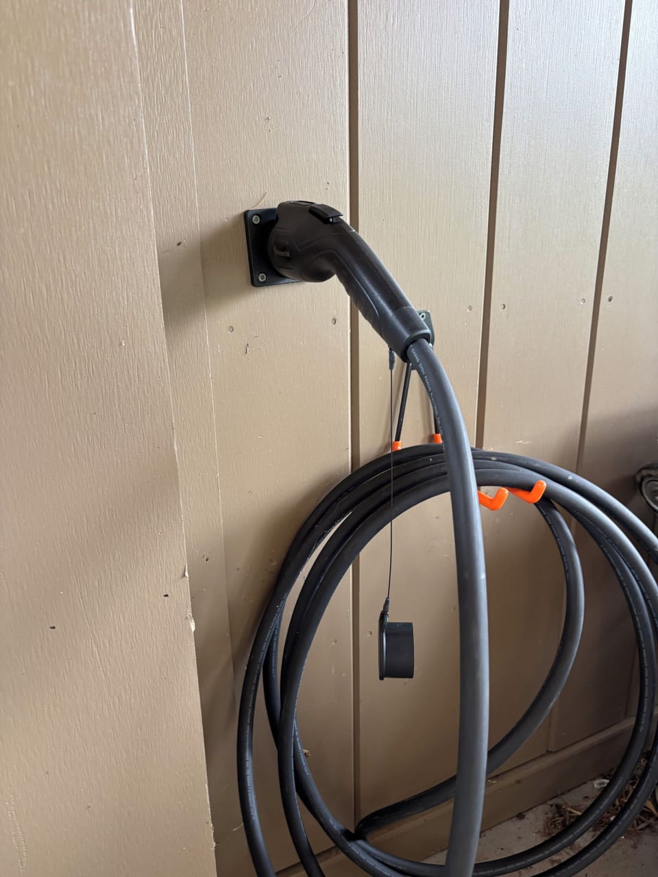Level 2 EV charger available in carport with dedicated parking spot