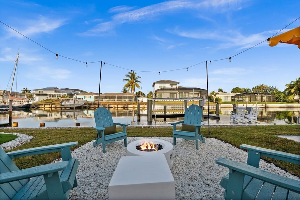 Outdoor Oasis: Gather around the fire pit with stunning water views and twinkling string lights!