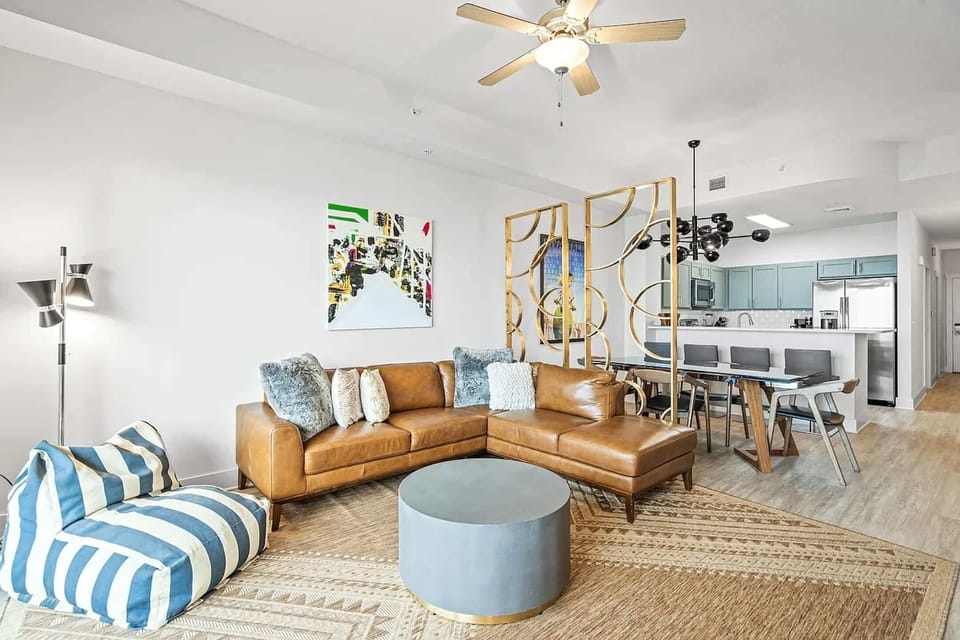 Bright living area with leather seating and TV
