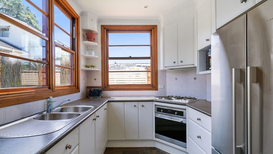 Fully equipped kitchen featuring modern appliances and a spacious layout.