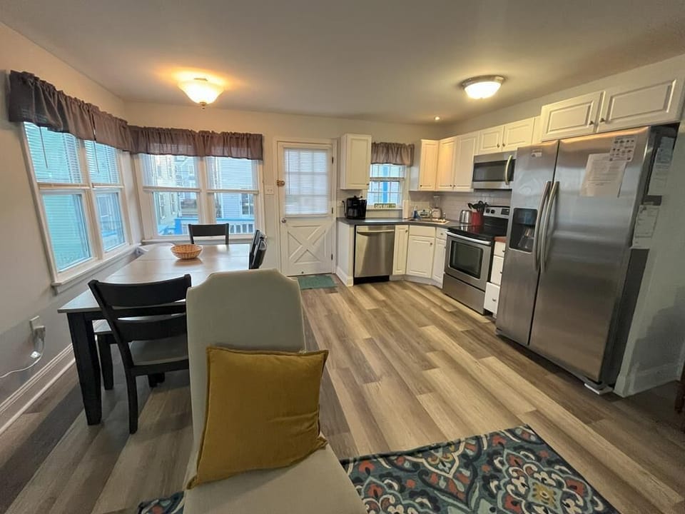 Open kitchen and dining space with large windows and stylish decor, ideal for casual meals or entertaining.