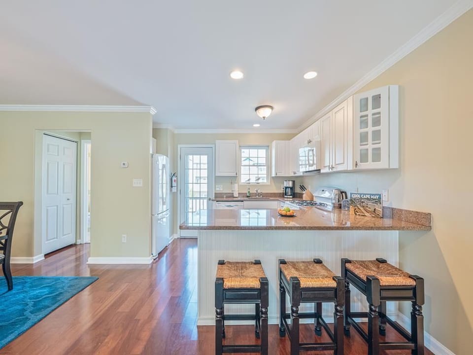 Full kitchen with a large island, bar seating, and modern appliances – perfect for preparing meals together.