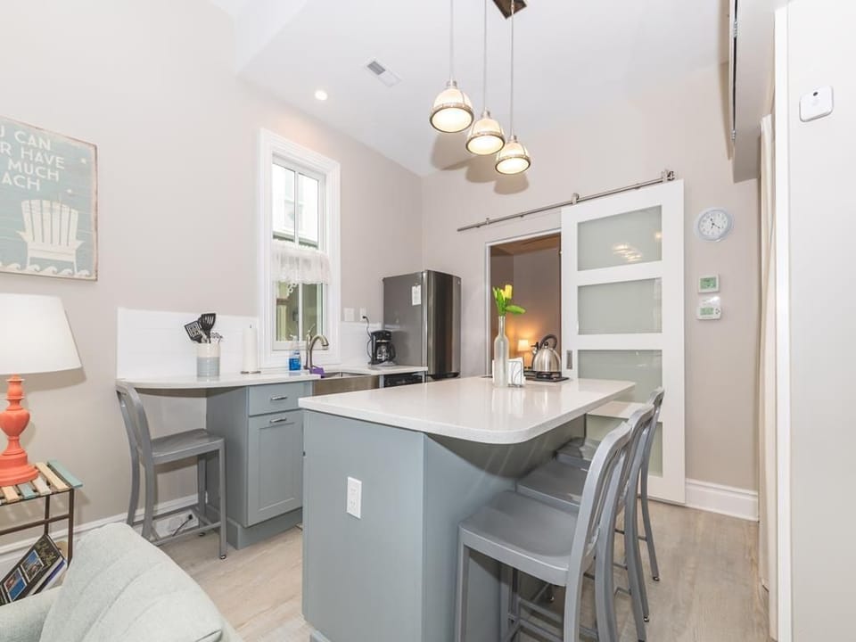 The kitchen island provides extra seating and prep space, perfect for casual dining or entertaining.