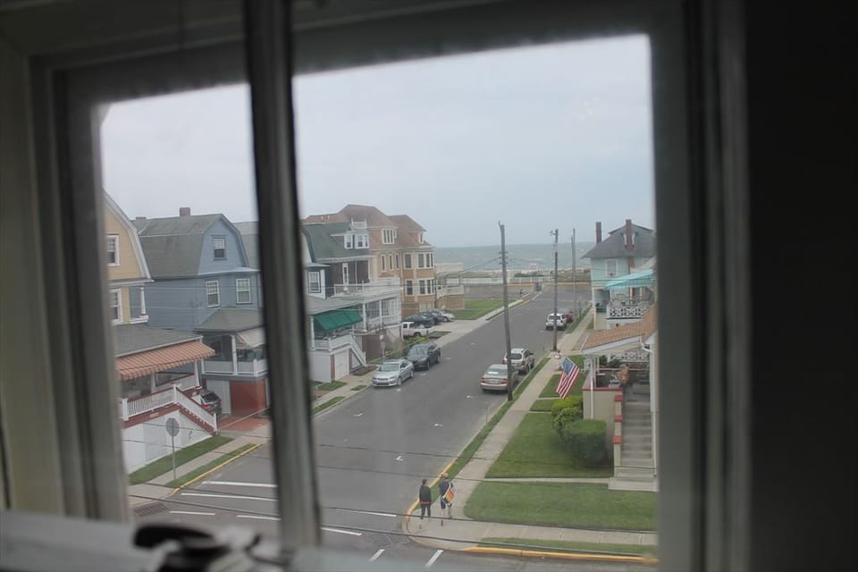 Street view showcasing the property's prime location, just steps to the beach.