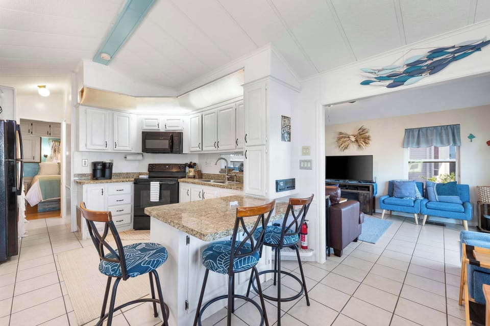 An open layout connects the kitchen, dining, and living areas