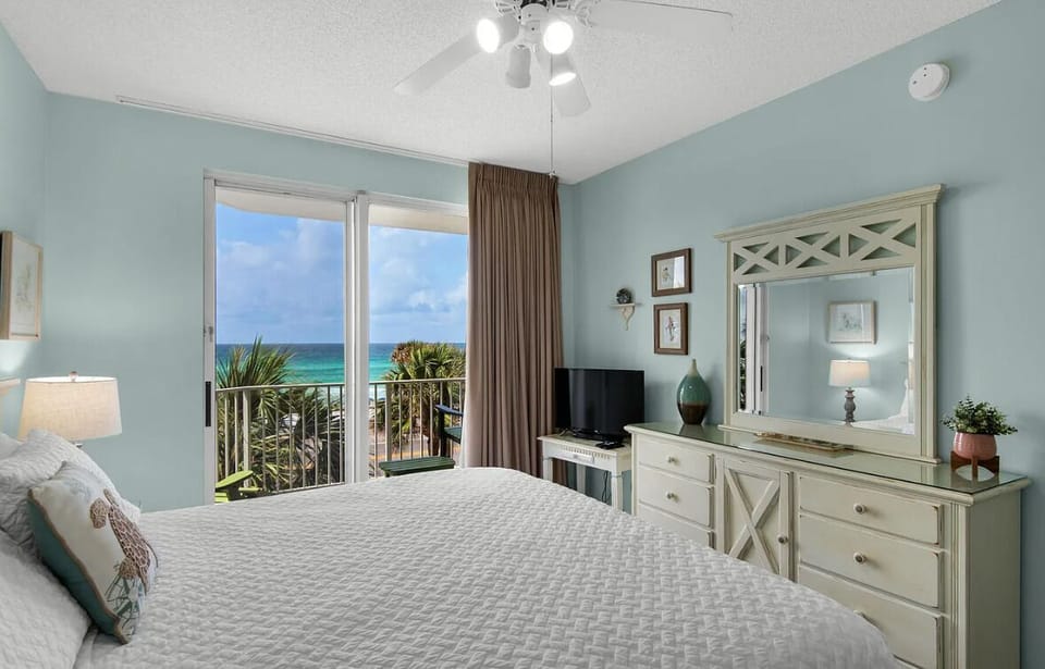 Big Gulf views from the primary bedroom which features a King Bed, Smart TV, large closet, and private bathroom with dual vanity + new walk in shower!