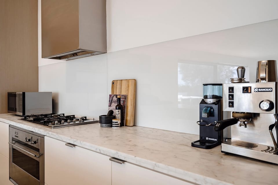 Chef’s Dream: The kitchen has marble bench tops, a cofee machine, 900mm oven, gas cooktop, and a dishwasher, making meal prep a pleasure