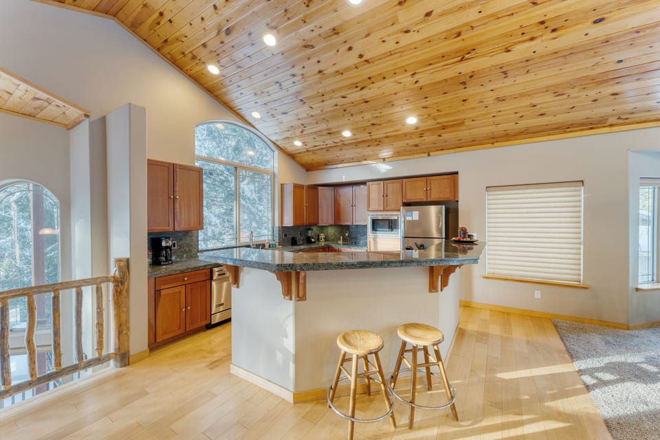 Fully equipped kitchen with a large island and barstool seating.