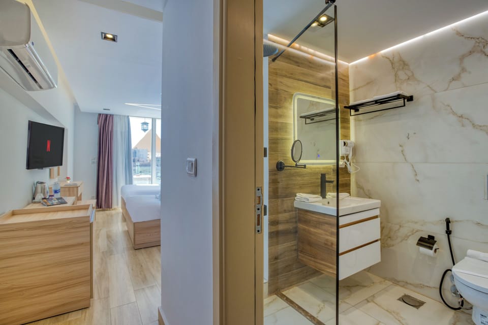 Deluxe Double or Twin Room, Balcony, Mountain View | Bathroom | Hair dryer, slippers, towels, soap