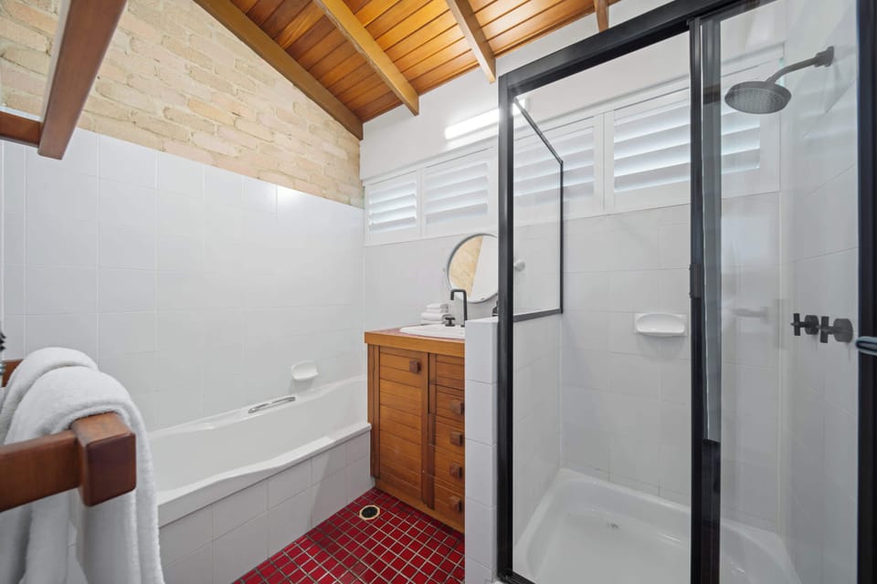 Modern bathroom with bathtub shower vanity and separate toilet