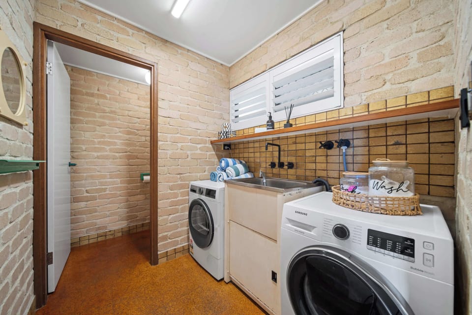 Convenient laundry space with washer dryer and additional toilet