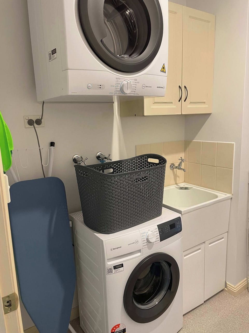 Well appointed laundry with washing machine and clothes dryer.