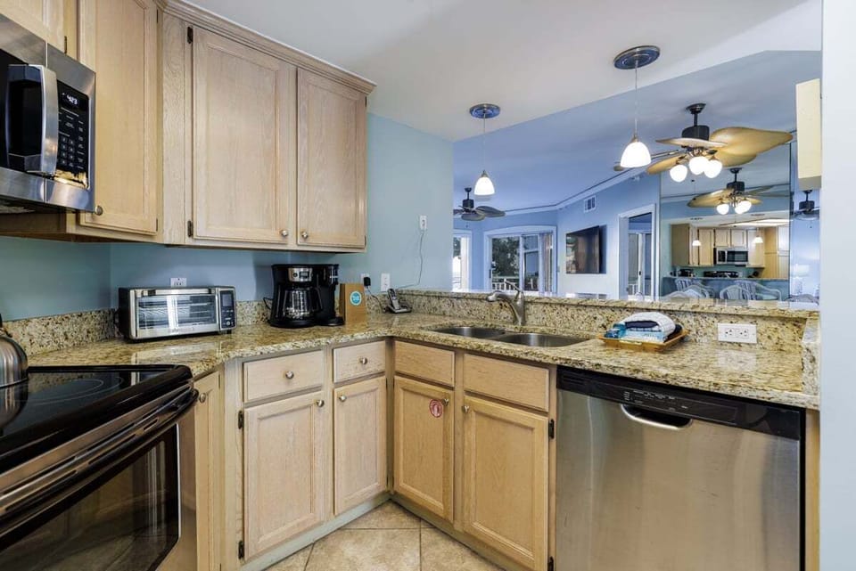 This well-equipped kitchen makes vacation meals easy, with generous granite countertops, ample cabinetry, and a practical layout that keeps everything within reach.