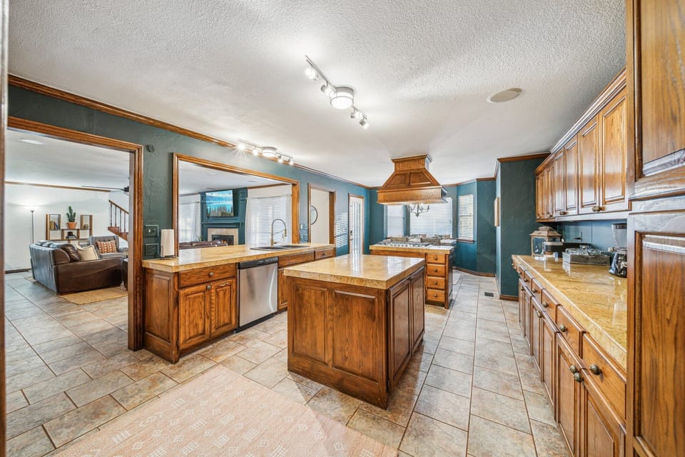 Full kitchen with eat in area, sub zero fridge, food warmer, prep islands, etc