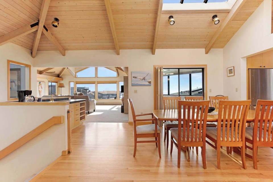 The entryway opens into a spacious floor plan with dining, living, and ocean-inspired touches throughout.