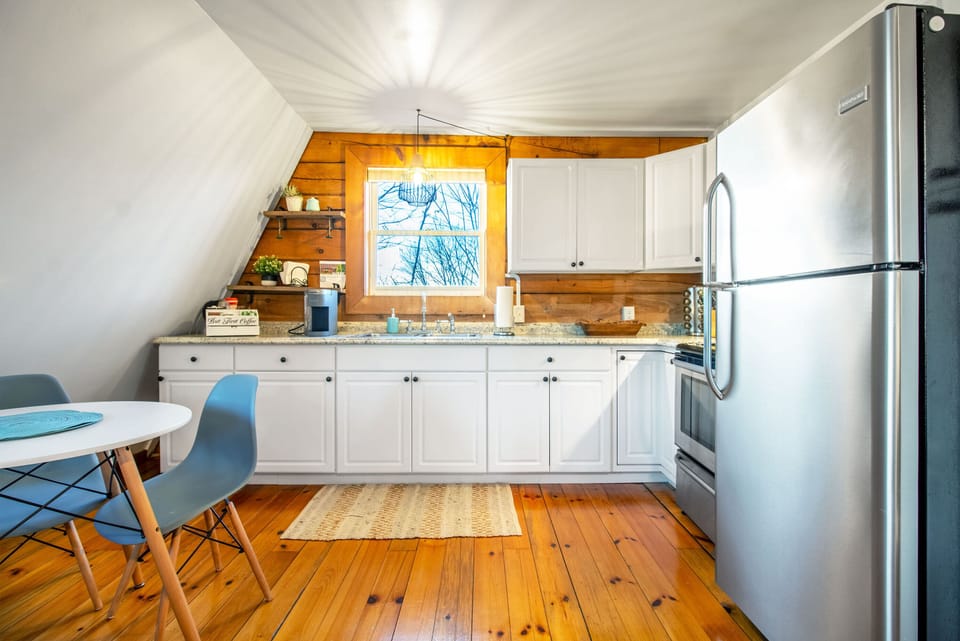 Kitchen with stove top, oven, refrigerator, and coffee maker