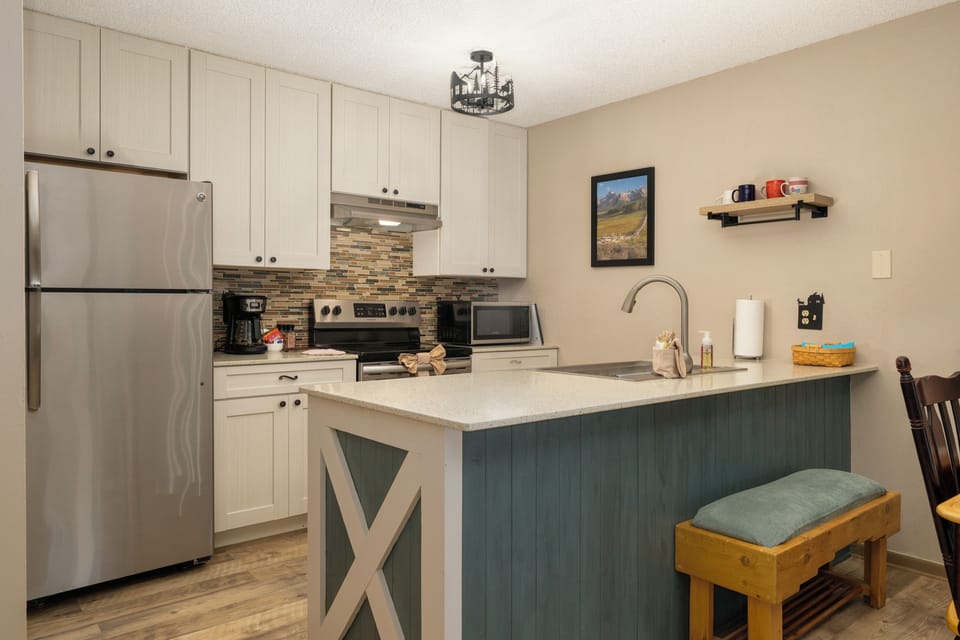 Your fully-equipped kitchen invites culinary adventures with modern appliances, granite counters, and a charming breakfast bar where morning coffee tastes even better.