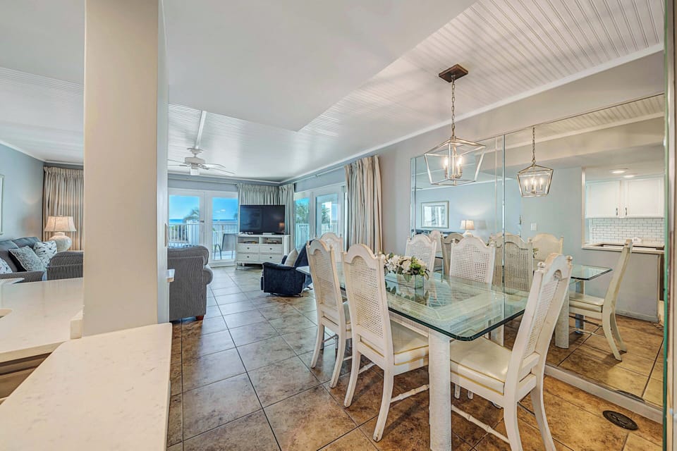 There is a dining table, perfect for enjoying a meal or playing a game, as well as additional breakfast bar seating.