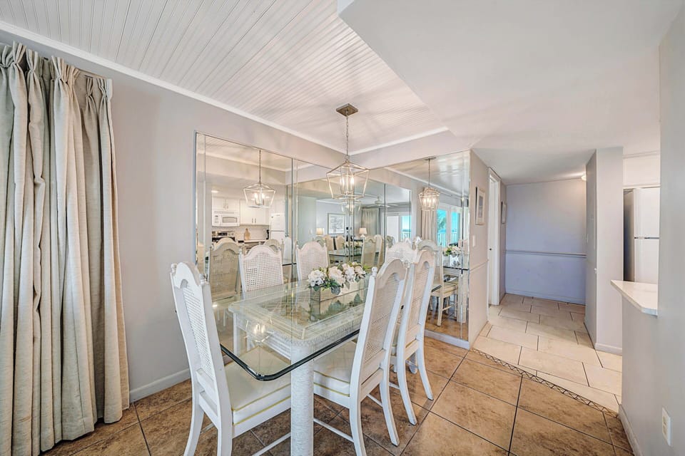 There is a dining table, perfect for enjoying a meal or playing a game, as well as additional breakfast bar seating.