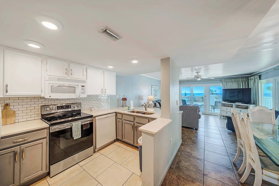 The fully equipped kitchen features quartz countertops and subway tile backsplash and has everything you need to prepare meals for family & friends.