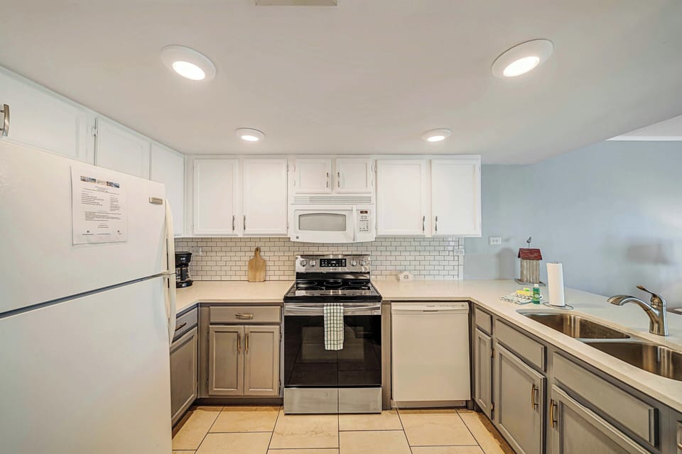 The fully equipped kitchen features quartz countertops and subway tile backsplash and has everything you need to prepare meals for family & friends.