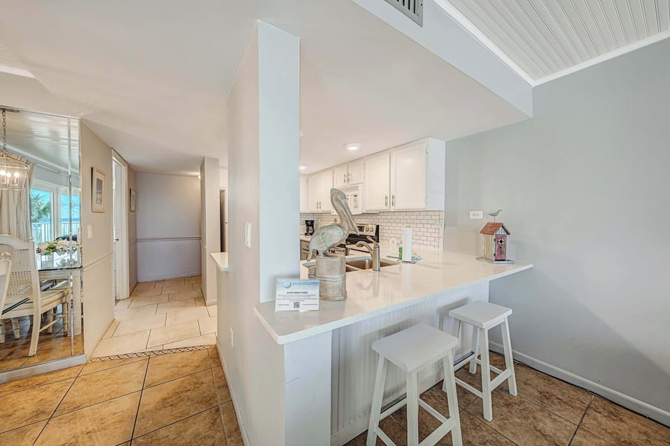 There is a dining table, perfect for enjoying a meal or playing a game, as well as additional breakfast bar seating.