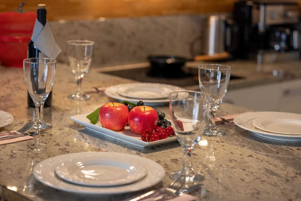 A close-up of a dining table elegantly set with wine glasses, plates, and decorative elements for a luxurious feel.