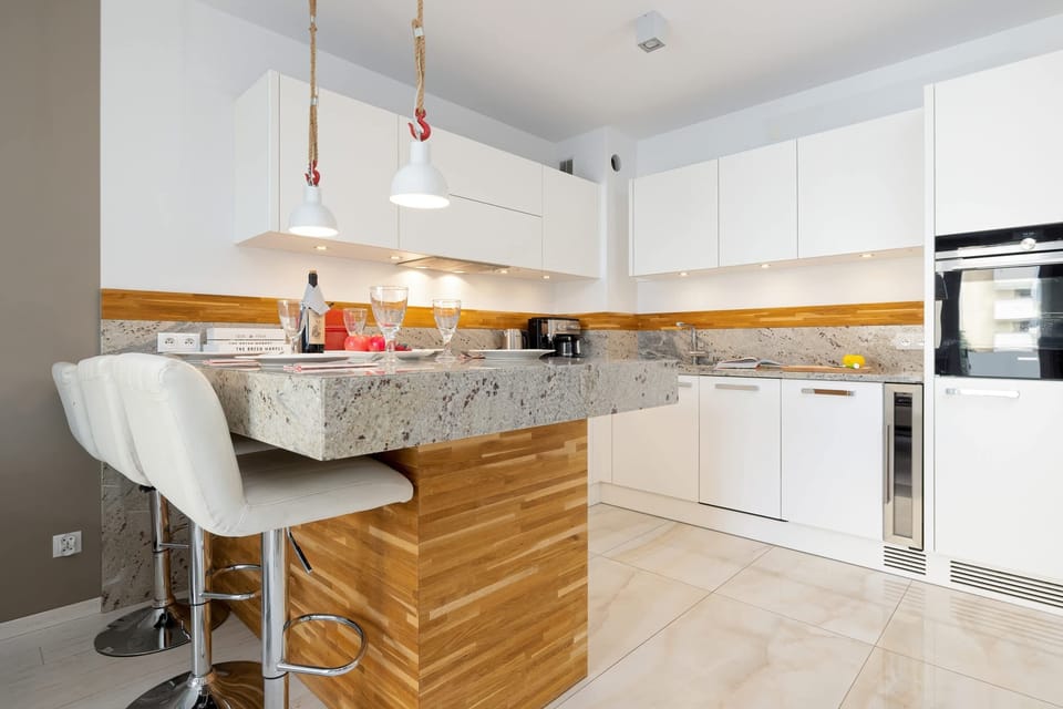 A stylish dining space with a  chairs, and designer pendant lighting for a cozy atmosphere.