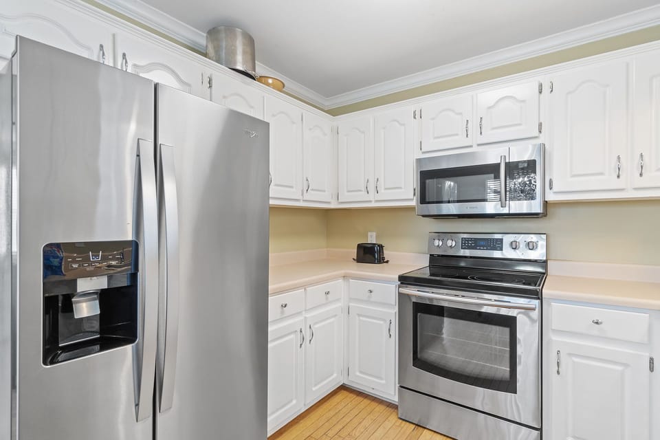 Kitchen is stocked with pots/pans/utensils.
