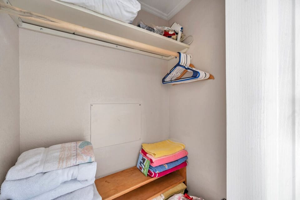 Open closet shelving w/ hangers and folded storage for easy unpacking.