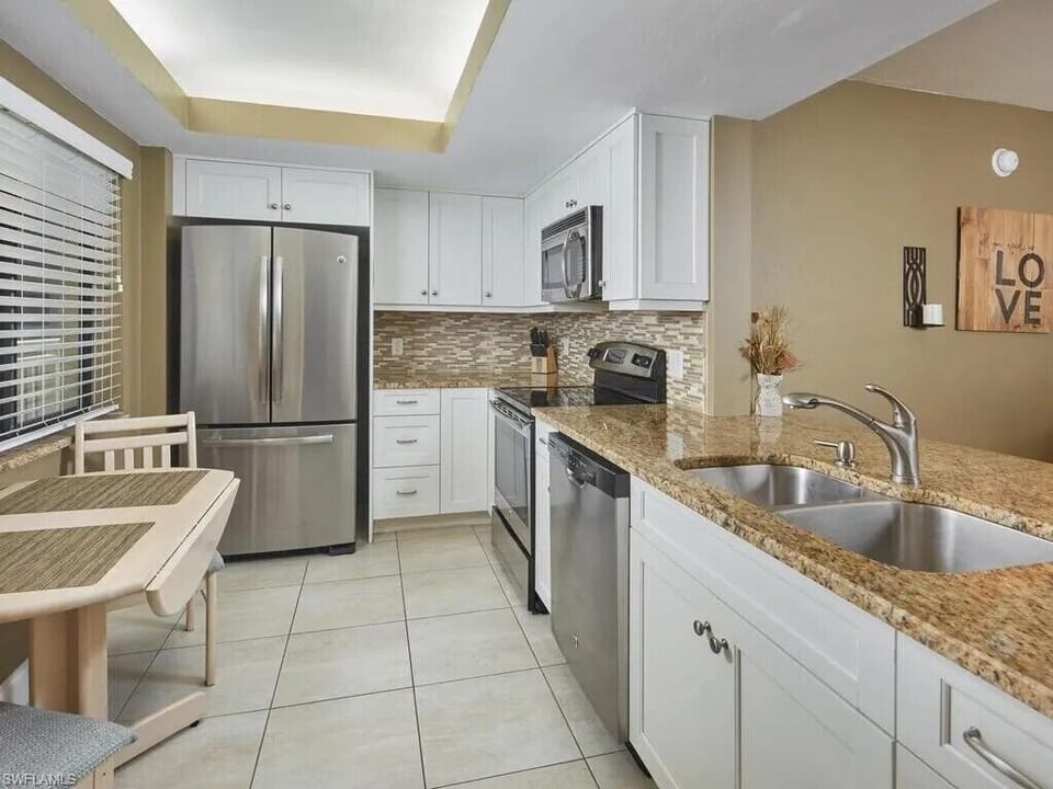 Kitchen with a new dishwasher and stove, espresso machine, and air fryer.