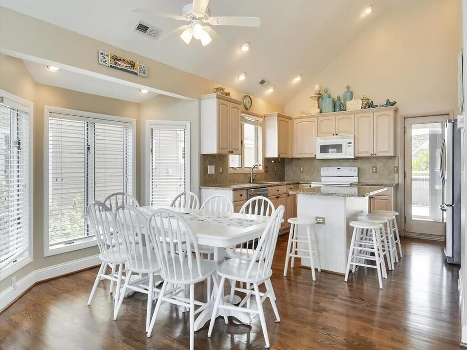 Spacious dining and kitchen area with an open layout, perfect for hosting meals and enjoying time with loved ones.