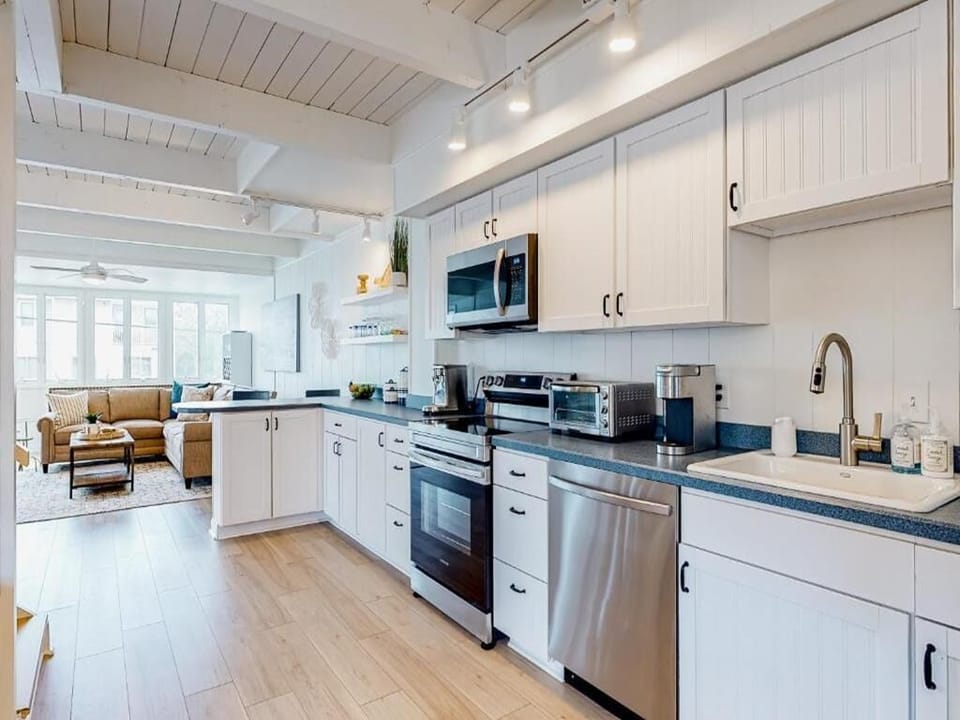 Bright and spacious kitchen, seamlessly connected to the living area, offering convenience and style for your culinary needs.