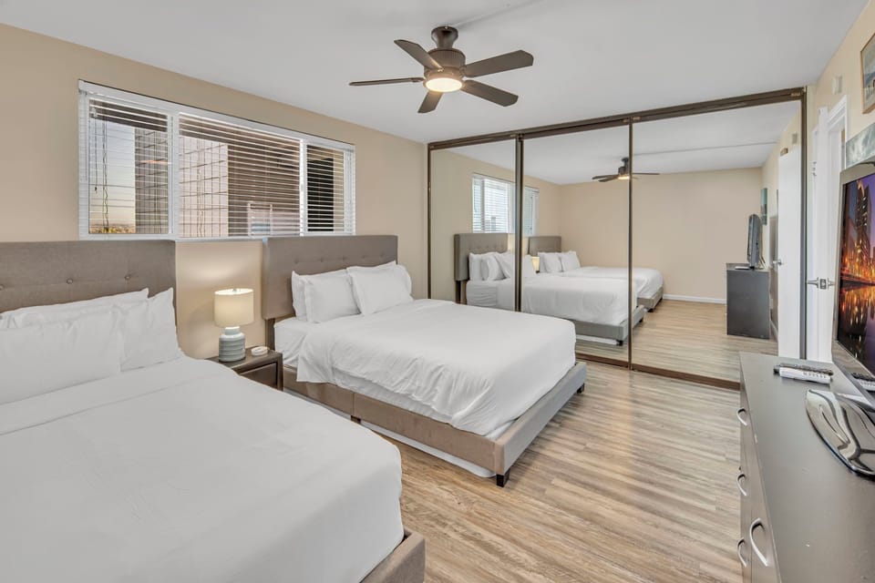 Bedroom with two queen beds, smart TV, ceiling fan, closet, portable AC units, portable space heaters