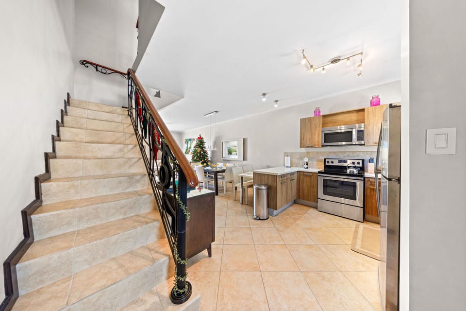 Elegant staircase with a decorative railing leading to the upper floors.