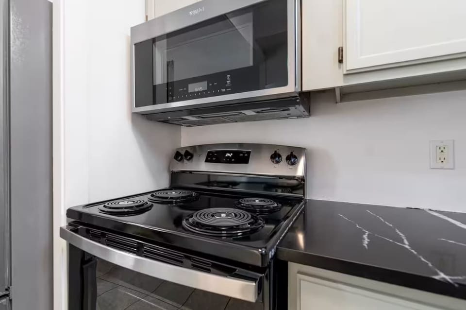 Kitchen: Bright and spacious kitchen featuring top-of-the-line appliances, plenty of counter space, and all the tools for preparing your favorite meals.