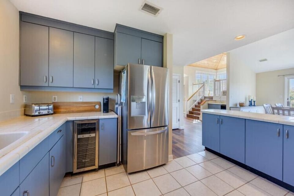 Your spacious kitchen features sleek cabinetry, stainless steel appliances, and ample counter space to prepare meals during your stay.