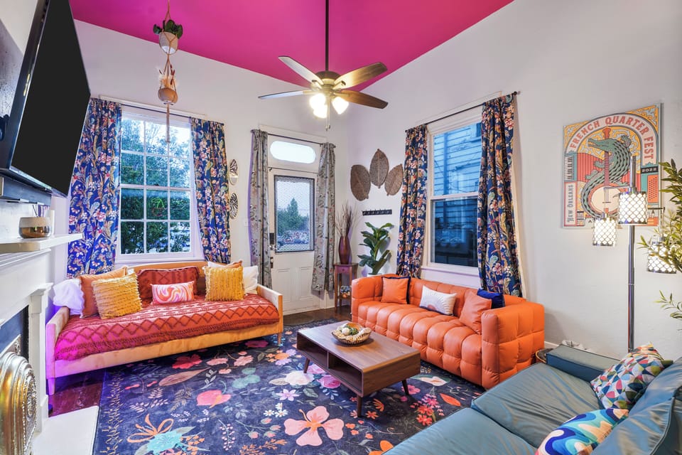 The colorful, eclectic living room reflects the vibrant nightlife of St. Claude Ave, just outside.